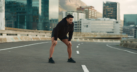 Image showing Man, athlete and breathe in road for fitness, exercise or wellness with city background or nature. Runner, person and relax or tired for workout, training and healthy body with sportswear in street