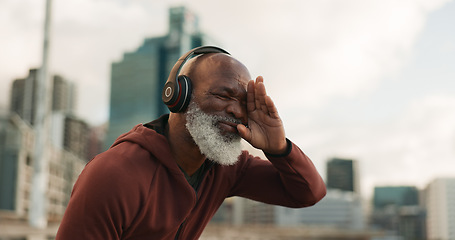 Image showing Senior, fitness and tired man in a city with music headphones for intense, cardio or training outdoor Sport, fatigue and elderly male runner stop for break, breathe and sweating from running workout