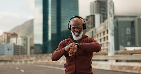 Image showing Man, music and smart watch in city for exercise, fitness performance and workout results. Happy senior african runner check timer, clock and healthy training progress with headphones in urban road