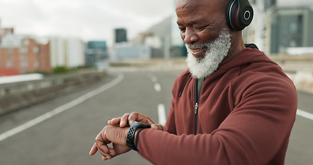 Image showing Man, music and smart watch in city for workout, cardio performance and exercise results. Happy senior african runner, sports gear and timer for clock, healthy training progress and headphones in road