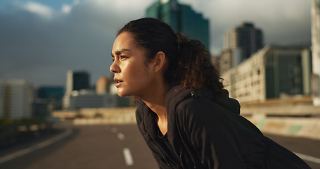 Image showing Woman, runner and breathe in road for fitness, exercise or wellness with city background or nature. Athlete, person and tired or break for workout, training and healthy body with sportswear in town