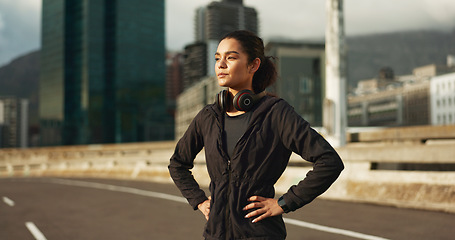 Image showing Thinking, city and woman training, active and looking at view, buildings and planning morning cardio, wellness or workout. Sunshine, road or fitness athlete, runner or person exercise in Chicago, USA