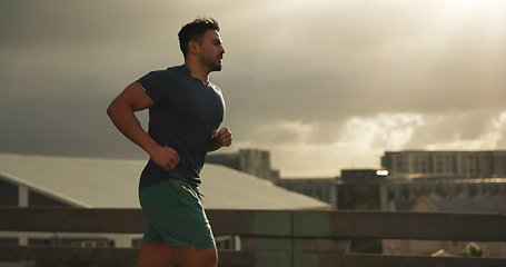 Image showing Running, city or man athlete in workout by training, cardio jog or fitness goals for marathon competition. Indian runner, wellness or progress in race, exercise or strong health body on urban road