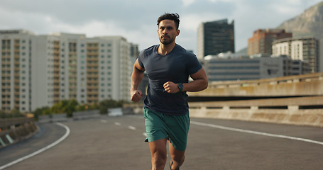 Image showing Running, city and man on road in training, endurance and fitness lifestyle for marathon competition. Indian runner, exercise commitment and body wellness for cape town race, progress and urban sport