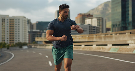 Image showing Running, road or man for time in training, practice or fitness goals for marathon competition. Indian athlete, wellness or speed runner in cape town race in watch progress, city street or health body