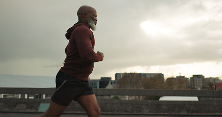 Image showing Man, city or senior runner with cardio workout in training, road fitness for health lifestyle. African athlete, retirement or wellness for strong body in leisure, cape town or exercise on urban road