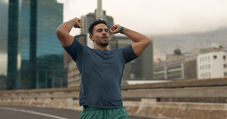 Image showing Fitness, winner and a sports man in the city for marathon running to improve cardio performance. Exercise, success and workout goals with a young runner or athlete on a bridge in an urban town