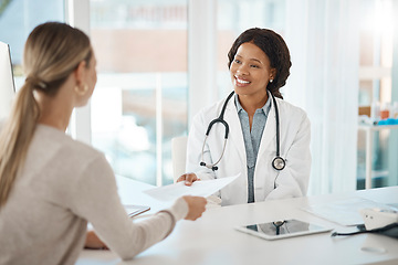 Image showing Doctor and patient discuss paperwork during medical consultation in a hospital. Healthcare professional, GP or physician prepare insurance document and checking personal information at a clinic