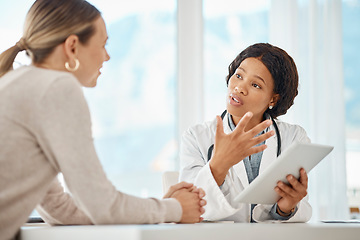 Image showing Female doctor browsing a tablet and giving medical advice to a woman. Surgeon, physician or GP showing patient scan results while explaining, consulting and advising surgery procedure at a hospital