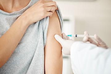 Image showing Vaccine, injection and virus cure for covid, disease and pandemic illness from doctor, healthcare or medical professional. Closeup hands, arm and needle or syringe being injected into female patient