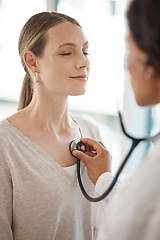 Image showing Checking and hearing heart rate with a working doctor consulting the wellness and health of a woman. Clinic checkup with a medical professional and patient at a healthcare center or hospital