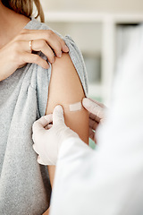 Image showing Covid, vaccine and injection with a doctor placing a plaster on the arm of a female patient in the hospital after a booster shot. Closeup of cure and treatment during the corona virus pandemic