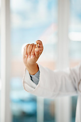 Image showing Hand holding medicine, tablet and healthcare doctor holding a pill for remedy, cure for sickness and medication for good health. Closeup of a medical professional showing a vitamin or supplement