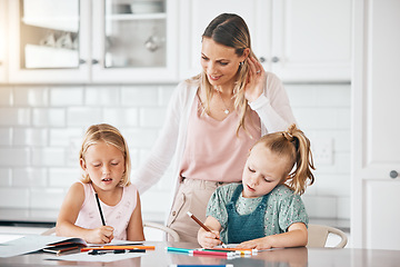 Image showing Homework, education and learning during homeschool lesson with their mother on the kitchen counter. Cute little girls doing educational drawing with color pencils assistant or help from their mom