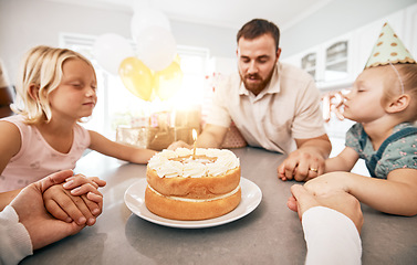 Image showing Family praying at birthday party, making a wish with cake and celebrating a special occasion together at home. Parents teaching children faith, saying a prayer and sitting at table during celebration