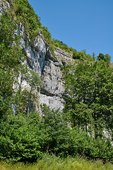Image showing Landscape mountain view of steep stone cliffs and lush green foliage with trees in remote countryside or a nature reserve. Environment conservation of scenic hiking rock climbing location for tourism