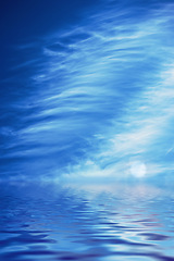 Image showing Blue ocean with a cloudy sky showing light reflection on water for creative copy space background. Abstract seascape with round moon and ripple effect or wave pattern on quiet lake or peaceful puddle