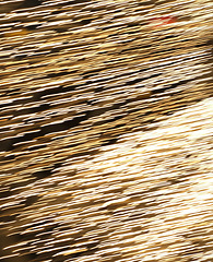 Image showing Flying fire sparks on a black background. Abstract steel wool sparkles or embers effect to use as a background for the welding industry or as a celebration backdrop. Glowing bokeh lights at night