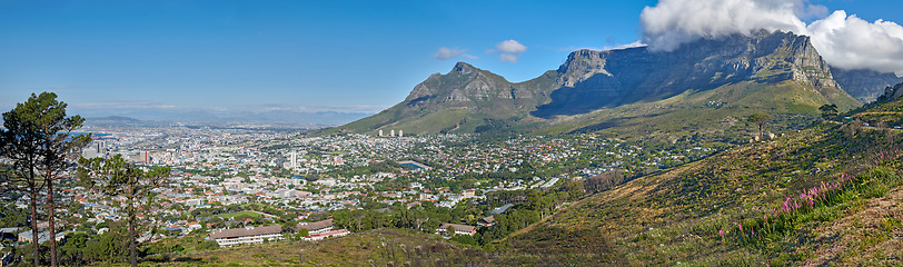 Image showing Panoramic landscape view of the majestic Table Mountain and city of Cape Town in South Africa. Beautiful scenery of a popular tourist destination and national landmark with cloudy blue sky copy space