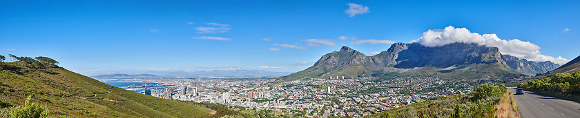 Image showing Mountain landscape and panorama view of coastal city, residential buildings or infrastructure in famous travel or tourism destination. Copy space and scenic blue sky of Table Mountain in South Africa