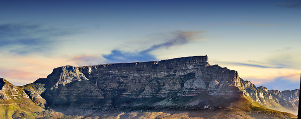 Image showing Copy space with scenic landscape of Table Mountain in Cape Town with cloudy blue sky background. Steep rocky mountainside with green valley. Breathtaking and magnificent views of the beauty in nature