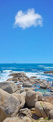 Image showing Boulders at a beach shore with majestic ocean across the horizon. Copyspace at sea with blue sky background and rocky coast in Camps Bay, South Africa. Calm and scenic landscape for a summer holiday