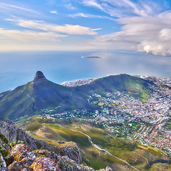 Image showing Aerial landscape view of Lions Head and surroundings in Cape Town, South Africa. Scenic natural landmark of a popular mountain against a cloudy blue sky in a beautiful urban city from above