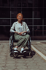 Image showing In front of a modern corporate building, a young woman sitting in a wheelchair confidently, symbolizing empowerment, inclusivity, and the strength to overcome challenges in the business world