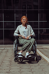 Image showing In front of a modern corporate building, a young woman sitting in a wheelchair confidently, symbolizing empowerment, inclusivity, and the strength to overcome challenges in the business world