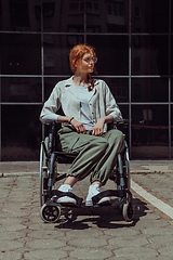 Image showing In front of a modern corporate building, a young woman sitting in a wheelchair confidently, symbolizing empowerment, inclusivity, and the strength to overcome challenges in the business world