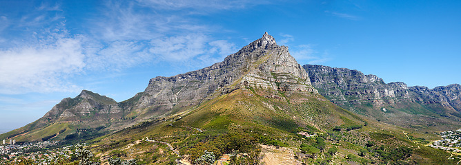 Image showing Panoramic landscape view of the majestic Table Mountain, Cape Town, South Africa. Beautiful scenery of a popular tourist attraction, destination and national landmark with cloudy blue sky copy space