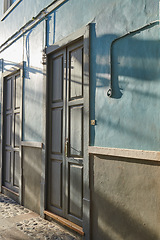 Image showing Historic Spanish architecture outdoors of a building in a overseas. Backdoor of a home or residential building. Two old blue doors to a traditional house outside in Santa Cruz de La Palma, Spain.