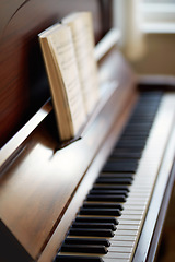 Image showing The piano. A vintage grand piano with a book of sheet music for education. An antique and classic keyboard is used to develop skills. A classical wooden musical instrument for practising music.