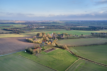 Image showing Drone point of view of private farming estate growing rye, wheat and sunflowers in remote farms and fields in Jutland, Denmark. Scenic aerial landscape of agriculture in green and serene countryside