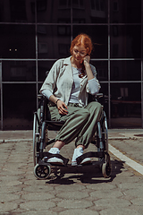 Image showing In front of a modern corporate building, a young woman sitting in a wheelchair confidently, symbolizing empowerment, inclusivity, and the strength to overcome challenges in the business world