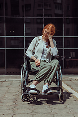 Image showing In front of a modern corporate building, a young woman sitting in a wheelchair confidently, symbolizing empowerment, inclusivity, and the strength to overcome challenges in the business world