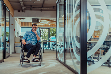 Image showing In a large modern corporation, a determined businessman in a wheelchair navigates through a hallway, embodying empowerment and inclusivity in the corporate world.