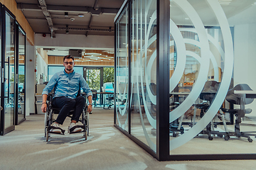 Image showing In a large modern corporation, a determined businessman in a wheelchair navigates through a hallway, embodying empowerment and inclusivity in the corporate world.