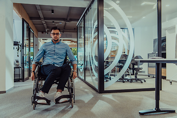 Image showing In a large modern corporation, a determined businessman in a wheelchair navigates through a hallway, embodying empowerment and inclusivity in the corporate world.