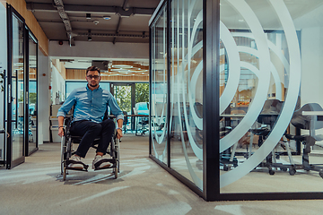 Image showing In a large modern corporation, a determined businessman in a wheelchair navigates through a hallway, embodying empowerment and inclusivity in the corporate world.