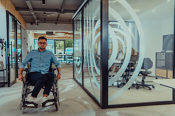 Image showing In a large modern corporation, a determined businessman in a wheelchair navigates through a hallway, embodying empowerment and inclusivity in the corporate world.