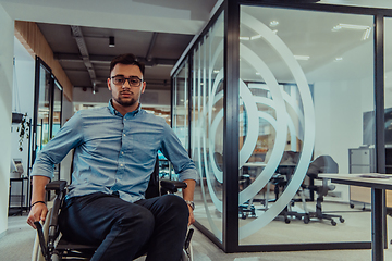 Image showing In a large modern corporation, a determined businessman in a wheelchair navigates through a hallway, embodying empowerment and inclusivity in the corporate world.