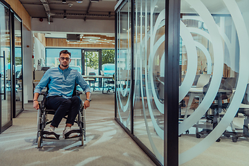 Image showing In a large modern corporation, a determined businessman in a wheelchair navigates through a hallway, embodying empowerment and inclusivity in the corporate world.
