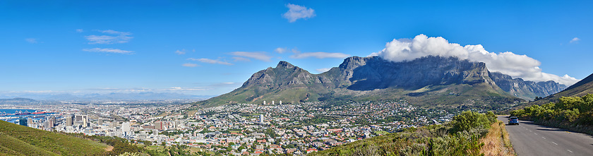 Image showing City landscape near mountains with a cloudy blue sky background on a sunny summer day. Beautiful cityscape of Cape Town, South Africa as a travel vacation or holiday destination in a coastal location