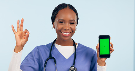 Image showing Green screen, okay sign and portrait of doctor with phone for telehealth, wellness app or medical news. Healthcare mockup, clinic website and woman with approval hand emoji on smartphone in studio