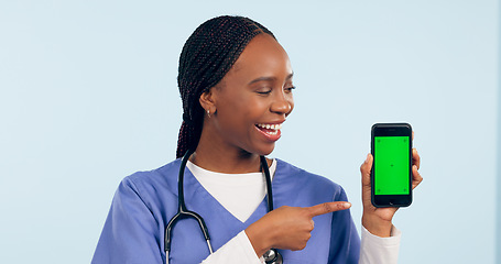 Image showing Green screen, doctor and woman with phone pointing for telehealth, wellness app and medical news. Healthcare, mockup and person on smartphone for clinic website, online promo and contact in studio