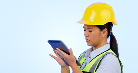 Image showing Woman, engineer and maintenance with tablet for construction, safety and studio by blue background. Asian female, architecture and development or real estate, tech and project management in mockup