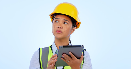 Image showing Engineer, woman and thinking with tablet for construction, project management and studio by blue background. Asian female, architecture and development or real estate, planning and safety in mockup