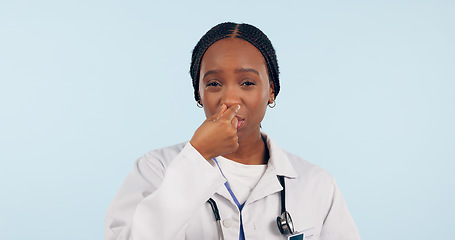 Image showing Portrait, black woman and doctor with bad smell in studio isolated on blue background mockup space. Face, intolerable stench and medical professional holding breath, nose and disgust for strong odor