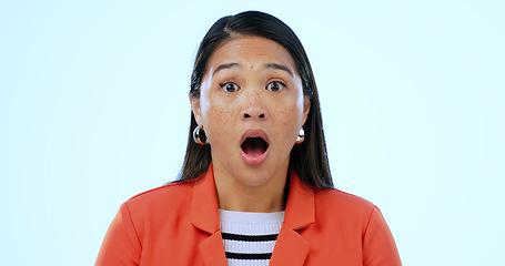 Image showing Portrait, wow and shock with an asian woman in studio on a blue background to hear gossip or an announcement. Face, emoji and surprise with a mind blown young person looking amazed by fake news
